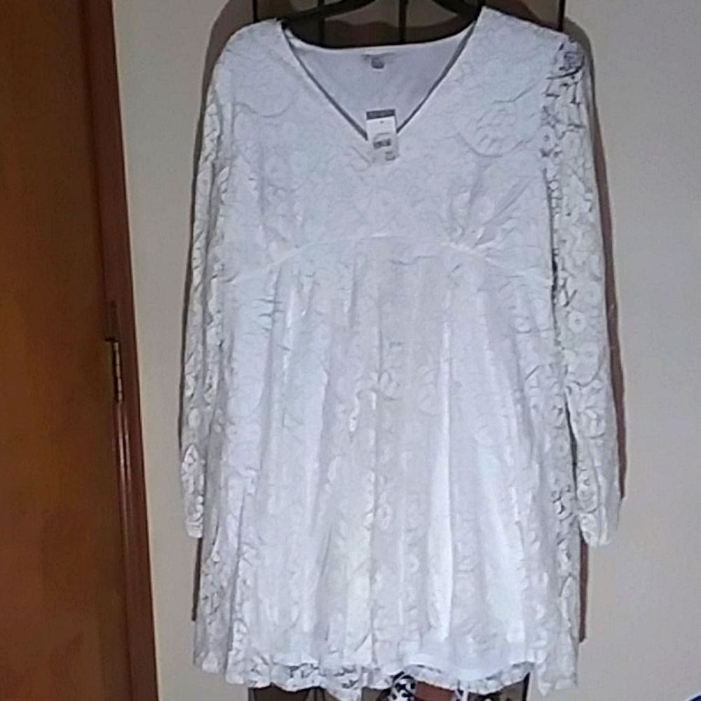 A white lacy dress with slits in sleeves